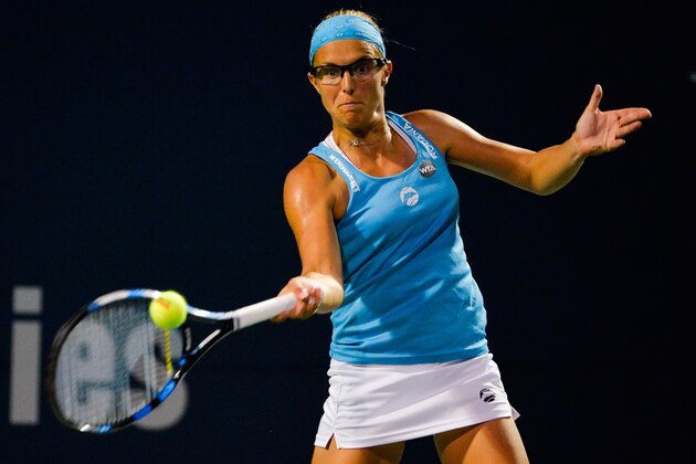 NEW HAVEN, CT - AUGUST 25:  Kirsten Flipkens of Belgium returns a shot to Agnieszka Radwanska of Poland on day 5 of the Connecticut Open at the Connecticut Tennis Center at Yale on August 25, 2016 in New Haven, Connecticut.  (Photo by Alex Goodlett/Getty Images)
