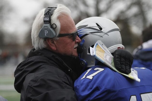 Kevin Donley embraces running back Justin Green after a touchdown run seals the coach's 300th career win.