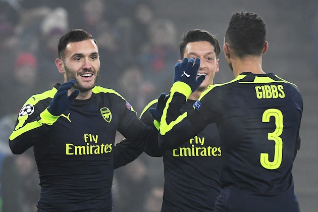 Arsenal's Spanish forward Lucas Perez (L) celebrates with his teammate Arsenal's German midfielder Mesut Ozil (2ndR) and Arsenal's English defender Kieran Gibbs after scoring a goal during the UEFA Champions league Group A football match between FC Basel 1893 and Arsenal FC on December 6, 2016 at the St Jakob Park stadium in Basel. / AFP / Patrick HERTZOG        (Photo credit should read PATRICK HERTZOG/AFP/Getty Images)
