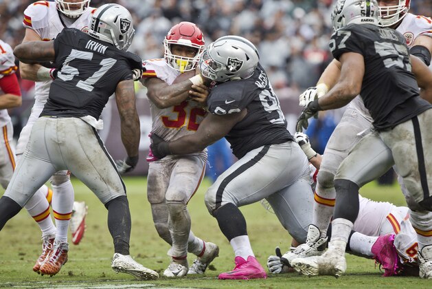 OAKLAND, CA - OCTOBER 16:  Defensive tackle Stacy McGee #92 of the Oakland Raiders stops running back Spencer Ware #32 of the Kansas City Chiefs for a loss of two yards in the second quarter on October 16, 2016 at Oakland-Alameda County Coliseum in Oakland, California.  The Chiefs won 26-10.  (Photo by Brian Bahr/Getty Images)