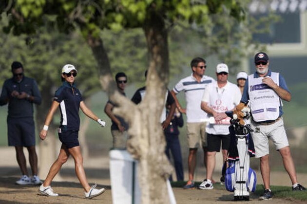 Anne-Lise Caudal of France studies her shot next to her caddie on the 10th hole during the 1st round of Dubai Ladies Masters golf tournament in Dubai, United Arab Emirates, Wednesday, Dec. 7, 2016. (AP Photo/Kamran Jebreili)