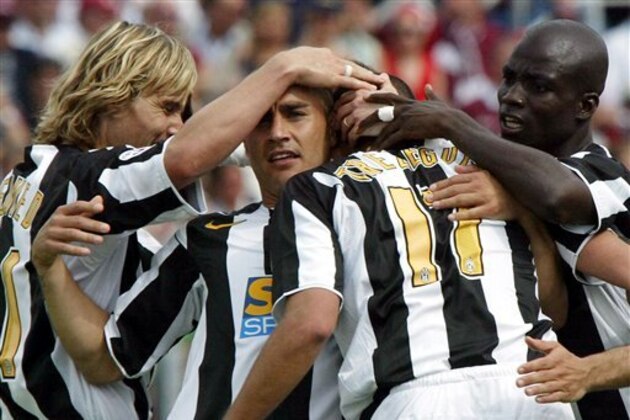 Juventus striker David Trezeguet, bach to camera, of France celebrates with his teammates Pavel Nedved, left, of Czech Republic, Fabio Cannavaro, second from left, and Olivier Kapo', of Ivory Cost, after scoring during the Italian first division soccer match between Livorno and Juventus at the Franchi stadium in Livorno, Italy, Sunday, May 22, 2005. Juventus won  the italian Serie A  title, the 28th