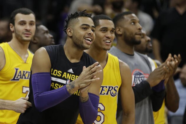 Los Angeles Lakers' D'Angelo Russell, second from left and Jordan Clarkson, third from left, join their teammates in celebrating in the closing moments of the Lakers 101-91 win over the Sacramento Kings in an NBA basketball game in Sacramento, Calif., Thursday, Nov. 10, 2016. (AP Photo/Rich Pedroncelli)