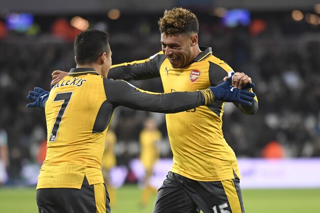 Arsenal's Chilean striker Alexis Sanchez (L) celebrates with Arsenal's English midfielder Alex Oxlade-Chamberlain after scoring his third goal, the team's fifth, during the English Premier League football match between West Ham United and Arsenal at The London Stadium, in east London on December 3, 2016.
Arsenal won the game 5-1. / AFP / Justin TALLIS / RESTRICTED TO EDITORIAL USE. No use with unauthorized audio, video, data, fixture lists, club/league logos or 'live' services. Online in-match use limited to 75 images, no video emulation. No use in betting, games or single club/league/player publications.  /         (Photo credit should read JUSTIN TALLIS/AFP/Getty Images)