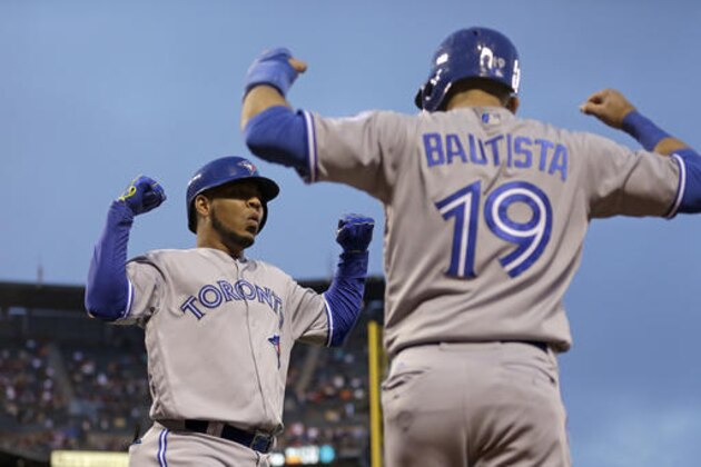 FILE -  This May 9, 2016 file photo shows Toronto Blue Jays' Edwin Encarnacion, left, celebrating with Jose Bautista (19) after hitting a two run home run off San Francisco Giants' Jake Peavy in the third inning of a baseball game in San Francisco. Bautista and Encarnacion were among 10 players to receive $17.2 million qualifying offers from their teams Monday, Nov. 7, 2016 as general managers gathered for their annual meeting. (AP Photo/Ben Margot, file)