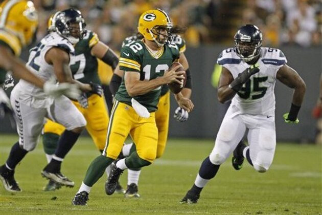 Green Bay Packers quarterback Aaron Rodgers scrambles with the ball against the Seattle Seahawks during an NFL football game Sunday Sept. 20, 2015, in Green Bay, Wis. (AP Photo/Matt Ludtke)