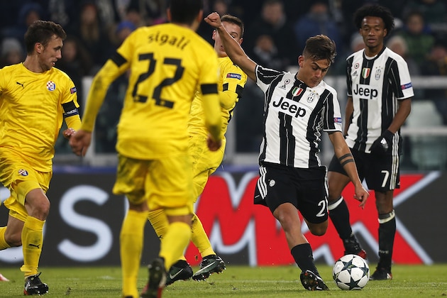 Juventus' forward Paulo Dybala from Argentina (2nd R) kicks the ball during the UEFA Champions League football match Juventus Vs GNK Dinamo Zagreb on December 7, 2016 at the 'Juventus Stadium' in Turin. / AFP / MARCO BERTORELLO        (Photo credit should read MARCO BERTORELLO/AFP/Getty Images)