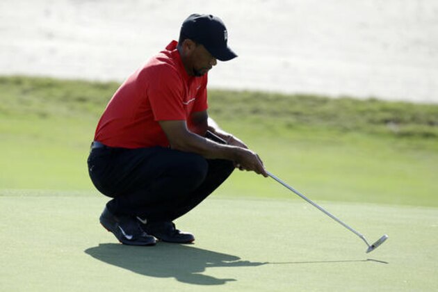 Tiger Woods waits to hit on the 14th green during the final round at the Hero World Challenge golf tournament, Sunday, Dec. 4, 2016, in Nassau, Bahamas. (AP Photo/Lynne Sladky)