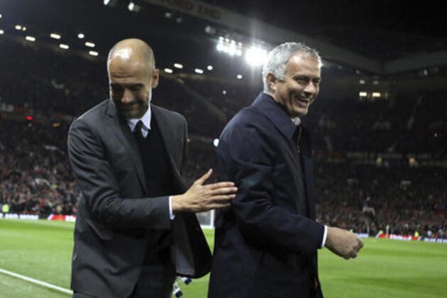 Manchester City's manager Pep Guardiola, left, and Manchester United's manager Jose Mourinho smile ahead of the English League Cup soccer match between Manchester United and Manchester City at Old Trafford stadium in Manchester, Wednesday, Oct. 26, 2016. (AP Photo/Dave Thompson)