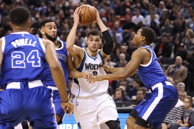 TORONTO, ON - DECEMBER 08: Zach LaVine #8 of the Minnesota Timberwolves goes to the basket against Cory Joseph #6 of the Toronto Raptors and Kyle Lowry #7 during NBA game action at Air Canada Centre on December 8, 2016 in Toronto, Canada. NOTE TO USER: User expressly acknowledges and agrees that, by downloading and or using this photograph, User is consenting to the terms and conditions of the Getty Images License Agreement.   (Photo by Tom Szczerbowski/Getty Images)