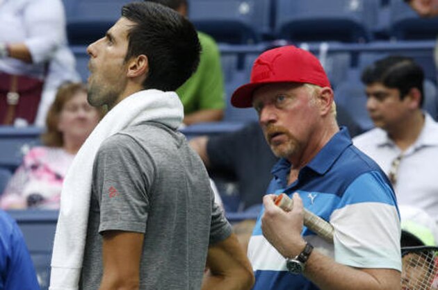 Novak Djokovic, of Serbia, left, talks with his coach Boris Becker, right, during a practice session after his opponent Mikhail Youzhny, of Russia, retired in the first set of their match during the third round of the U.S. Open tennis tournament, Friday, Sept. 2, 2016, in New York. (AP Photo/Jason DeCrow)