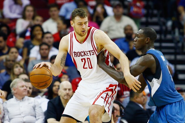 HOUSTON, TX - MARCH 18:  Donatas Motiejunas #20 of the Houston Rockets drives with the basketball against Gorgui Dieng #5 of the Minnesota Timberwolves during their game at the Toyota Center on March 18, 2016 in Houston, Texas.  NOTE TO USER: User expressly acknowledges and agrees that, by downloading and or using this Photograph, user is consenting to the terms and conditions of the Getty Images License Agreement.  (Photo by Scott Halleran/Getty Images)