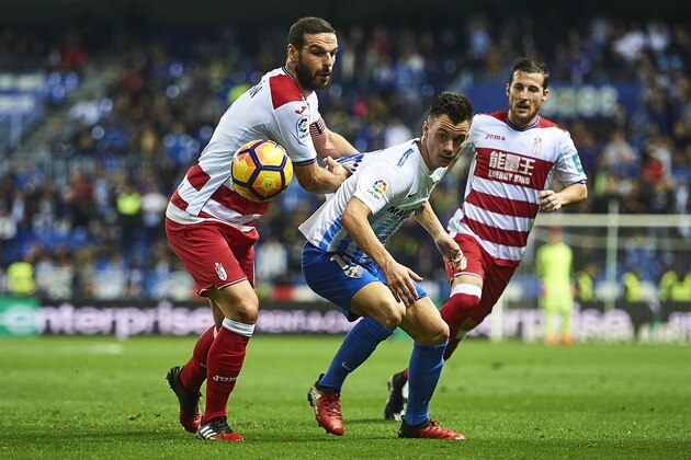 MALAGA, SPAIN - DECEMBER 09:  Juan Pablo Anor 'Juanpi' of Malaga CF (C) competes for the ball with David Rodriguez Lomban of Granada CF (L) during La Liga match between Malaga CF and Granada CF at La Rosaleda Stadium December 9, 2016 in Malaga, Spain.  (Photo by Aitor Alcalde Colomer/Getty Images)