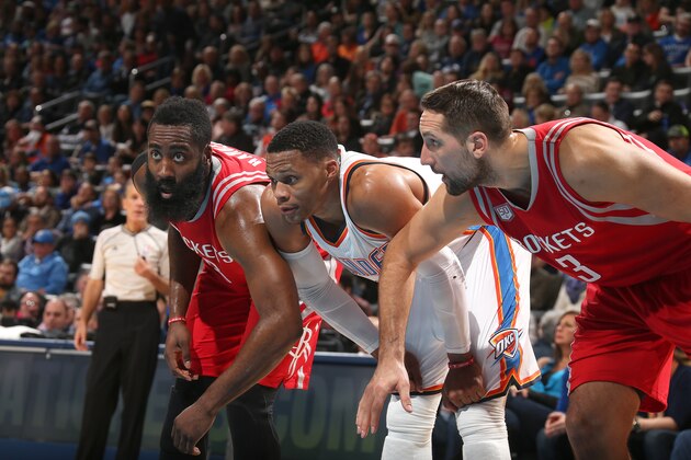 OKLAHOMA CITY, OK - DECEMBER 9: Russell Westbrook #0 of the Oklahoma City Thunder fights for position against James Harden #13 and Ryan Anderson #3 of the Houston Rockets on December 9, 2016 at Chesapeake Energy Arena in Oklahoma City, Oklahoma. NOTE TO USER: User expressly acknowledges and agrees that, by downloading and or using this photograph, User is consenting to the terms and conditions of the Getty Images License Agreement. Mandatory Copyright Notice: Copyright 2016 NBAE (Photo by Layne Murdoch/NBAE via Getty Images)