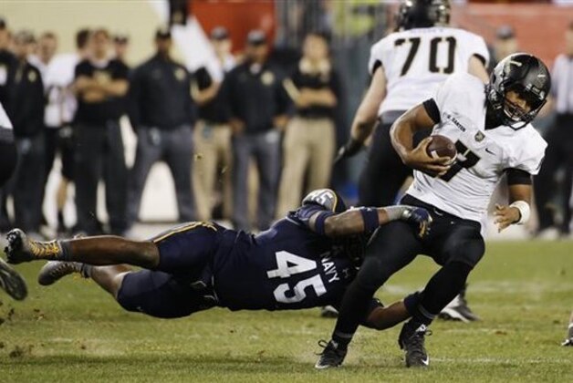 Army quarterback Chris Carter (7) is tackled by Navy linebacker D.J. Palmore (45) during the second half of an NCAA college football game Saturday, Dec. 12, 2015, in Philadelphia. (AP Photo/Matt Slocum)
