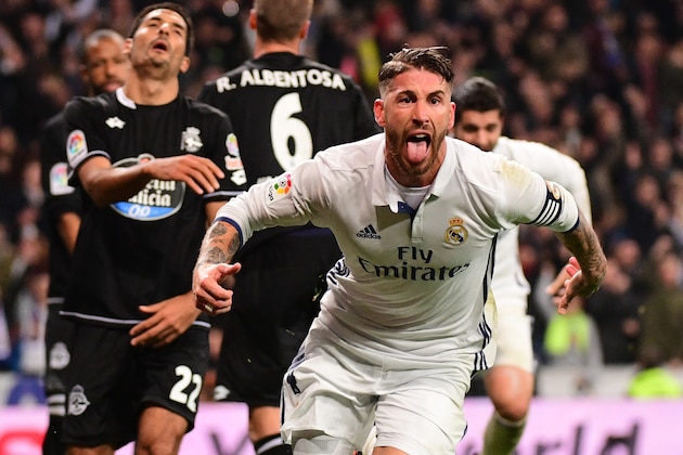 Real Madrid's defender Sergio Ramos celebrates after scoring during the Spanish league football match Real Madrid CF vs RC Deportivo at the Santiago Bernabeu stadium in Madrid on December 10, 2016. / AFP / PIERRE-PHILIPPE MARCOU        (Photo credit should read PIERRE-PHILIPPE MARCOU/AFP/Getty Images)