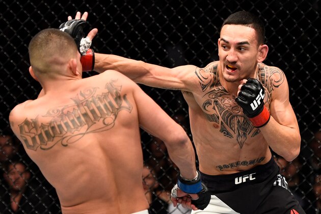 TORONTO, CANADA - DECEMBER 10:  (R-L) Max Holloway punches Anthony Pettis in their interim UFC featherweight championship bout during the UFC 206 event inside the Air Canada Centre on December 10, 2016 in Toronto, Ontario, Canada. (Photo by Jeff Bottari/Zuffa LLC/Zuffa LLC via Getty Images)