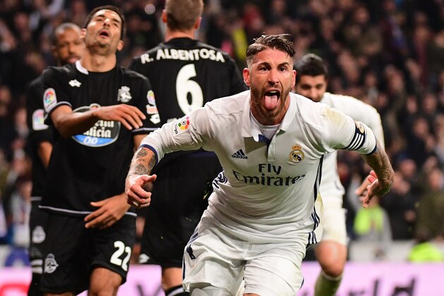 Real Madrid's defender Sergio Ramos celebrates after scoring during the Spanish league football match Real Madrid CF vs RC Deportivo at the Santiago Bernabeu stadium in Madrid on December 10, 2016. / AFP / PIERRE-PHILIPPE MARCOU        (Photo credit should read PIERRE-PHILIPPE MARCOU/AFP/Getty Images)