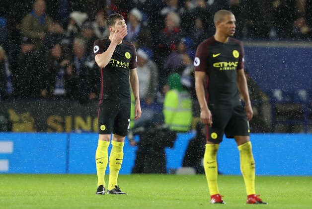 LEICESTER, ENGLAND - DECEMBER 10:  John Stones of Manchester City (L) is djected after Jamie Vardy of Leicester City (not pictured) scored his sides fourth goal during the Premier League match between Leicester City and Manchester City at the King Power Stadium on December 10, 2016 in Leicester, England.  (Photo by Christopher Lee/Getty Images)
