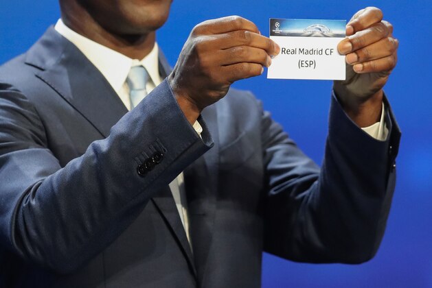 Dutch former football player Clarence Seedorf shows a piece of paper bearing the name of Real Madrid CF during the UEFA Champions League Group stage draw ceremony, on August 25, 2016 in Monaco. / AFP / Valery HACHE        (Photo credit should read VALERY HACHE/AFP/Getty Images)
