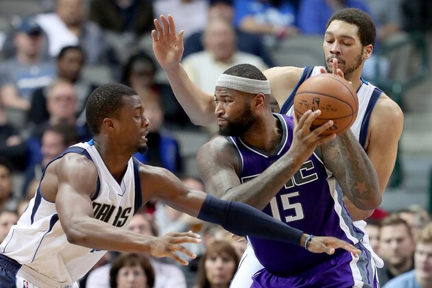 DALLAS, TX - DECEMBER 07:  DeMarcus Cousins #15 of the Sacramento Kings drives to the basket against Harrison Barnes #40 of the Dallas Mavericks and A.J. Hammons #20 of the Dallas Mavericks in the second half at American Airlines Center on December 7, 2016 in Dallas, Texas. NOTE TO USER: User expressly acknowledges and agrees that, by downloading and or using this photograph, User is consenting to the terms and conditions of the Getty Images License Agreement.  (Photo by Tom Pennington/Getty Images)