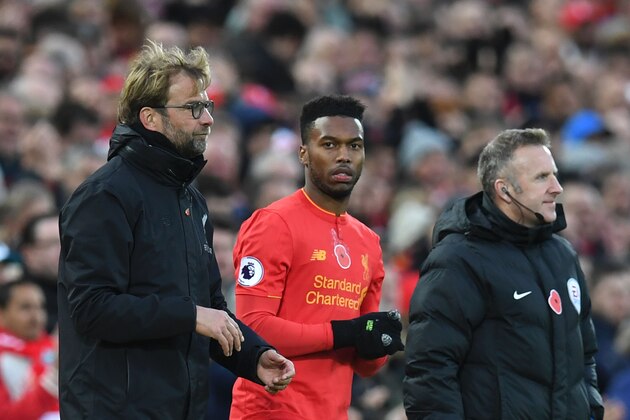 Liverpool's English striker Daniel Sturridge (C) stands alongside Liverpool's German manager Jurgen Klopp (L) as he waits to be substituted on to the pitch during the English Premier League football match between Liverpool and Watford at Anfield in Liverpool, north west England on November 6, 2016. / AFP / PAUL ELLIS / RESTRICTED TO EDITORIAL USE. No use with unauthorized audio, video, data, fixture lists, club/league logos or 'live' services. Online in-match use limited to 75 images, no video emulation. No use in betting, games or single club/league/player publications.  /         (Photo credit should read PAUL ELLIS/AFP/Getty Images)