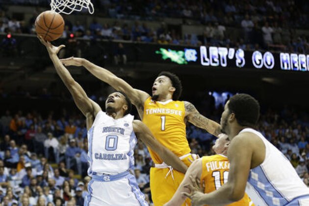 North Carolina's Nate Britt (0) drives to the basket as Tennessee's Lamonte Turner (1) defends during the first half of an NCAA college basketball game in Chapel Hill, N.C., Sunday, Dec. 11, 2016. (AP Photo/Gerry Broome)