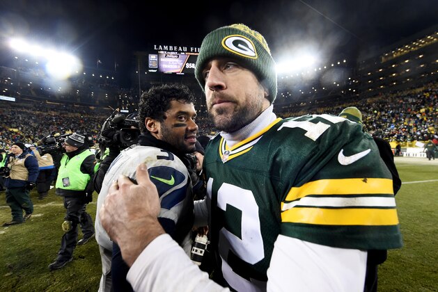 GREEN BAY, WI - DECEMBER 11:  Russell Wilson #3 of the Seattle Seahawks meets with Aaron Rodgers #12 of the Green Bay Packers after the Green Bay Packers beat the Seattle Seahawks 38-10 at Lambeau Field on December 11, 2016 in Green Bay, Wisconsin. (Photo by Stacy Revere/Getty Images)