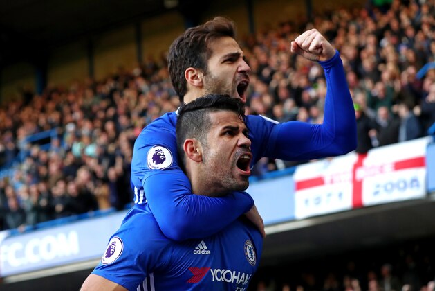 LONDON, ENGLAND - DECEMBER 11:  Diego Costa (bottom) of Chelsea celebrates scoring the opening goal with his team mate Cesc Fabregas (top) during the Premier League match between Chelsea and West Bromwich Albion at Stamford Bridge on December 11, 2016 in London, England.  (Photo by Clive Rose/Getty Images)