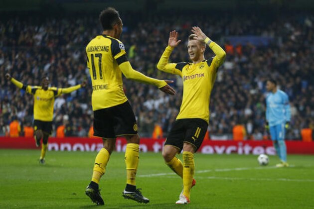 Dortmund's Marco Reus, right, celebrates with Pierre-Emerick Aubameyang after scoring his side's 2nd goal during the Champions League, Group F, soccer match between Real Madrid and Borrusia Dortmund at the Santiago Bernabeu stadium in Madrid, Spain, Wednesday, Dec. 7, 2016. (AP Photo/Francisco Seco)