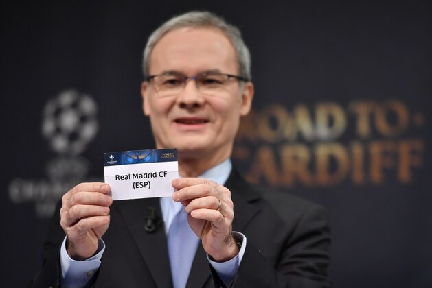 UEFA deputy secretary general Giorgio Marchetti shows the name of Real Madrid during the draw for the round of 16 of the UEFA Champions League football tournament at the UEFA headquarters in Nyon on December 12, 2016. / AFP / Fabrice COFFRINI        (Photo credit should read FABRICE COFFRINI/AFP/Getty Images)