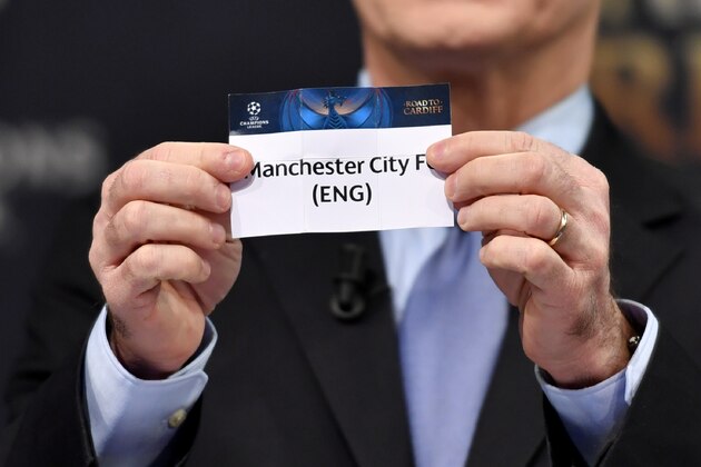 UEFA deputy secretary general Giorgio Marchetti shows the name of Manchester City during the draw for the round of 16 of the UEFA Champions League football tournament at the UEFA headquarters in Nyon on December 12, 2016. / AFP / Fabrice COFFRINI        (Photo credit should read FABRICE COFFRINI/AFP/Getty Images)