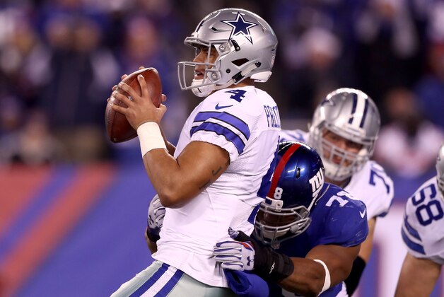 EAST RUTHERFORD, NJ - DECEMBER 11:  Dak Prescott #4 of the Dallas Cowboys is pressured by  Romeo Okwara #78 of the New York Giants in the fourth quarter at MetLife Stadium on December 11, 2016 in East Rutherford, New Jersey  (Photo by Elsa/Getty Images)