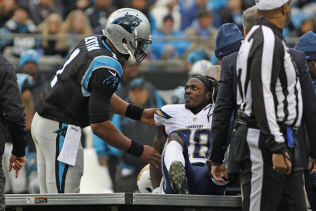 Carolina Panthers' Cam Newton (1) reaches out to injured San Diego Chargers' Melvin Gordon (28) in the first half of an NFL football game in Charlotte, N.C., Sunday, Dec. 11, 2016. (AP Photo/Bob Leverone)