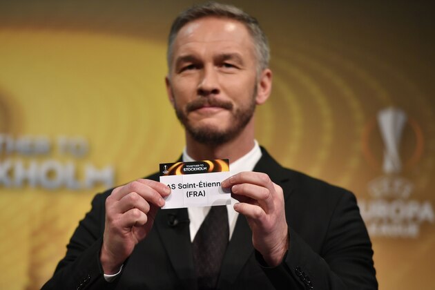 Sweden's former defender and 2017 Europa League final ambassador Patrik Andersson holds the name of Saint-Etienne during the draw for the round of 32 of the UEFA Europa League football tournament at the UEFA headquarters in Nyon on December 12, 2016. / AFP / Fabrice COFFRINI        (Photo credit should read FABRICE COFFRINI/AFP/Getty Images)
