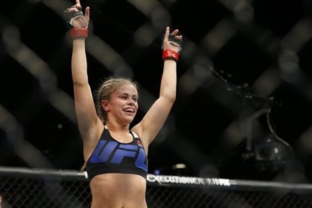 Paige VanZant celebrates after defeating Alex Chambers in their women’s straw weight mixed martial arts bout at UFC 191 on Saturday, Sept. 5, 2015, in Las Vegas. (AP Photo/John Locher)