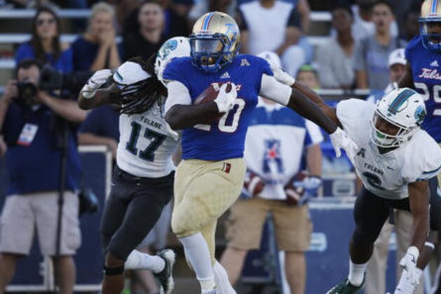 Tulsa running back James Flanders (20) carries past Tulane cornerback Parry Nickerson (17) and safety Jarrod Franklin (6) for a touchdown in the fourth quarter of an NCAA college football game in Tulsa, Okla., Saturday, Oct. 22, 2016. Tulsa won 50-27. (AP Photo/Sue Ogrocki)