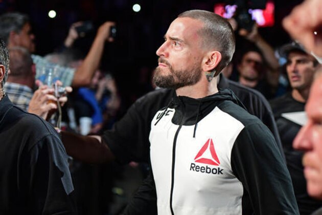 CM Punk walks to the octagon before a welterweight bout at UFC 203 on Saturday, Sept. 10, 2016, in Cleveland. (AP Photo/David Dermer)