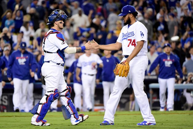 LOS ANGELES, CA - OCTOBER 18:  Catcher Yasmani Grandal #9 and Kenley Jansen #74 of the Los Angeles Dodgers celebrate the Dodgers 6-0 win against the Chicago Cubs in game three of the National League Championship Series at Dodger Stadium on October 18, 2016 in Los Angeles, California.  (Photo by Harry How/Getty Images)