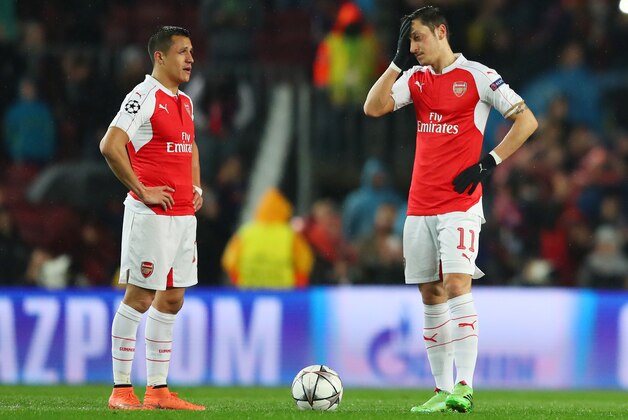 BARCELONA, SPAIN - MARCH 16: Alexis Sanchez (L) and Mesut Ozil (R) of Arsenal show their dejection after Barcelona's first goal during the UEFA Champions League round of 16, second Leg match between FC Barcelona and Arsenal FC at Camp Nou on March 16, 2016 in Barcelona, Spain.  (Photo by Richard Heathcote/Getty Images)