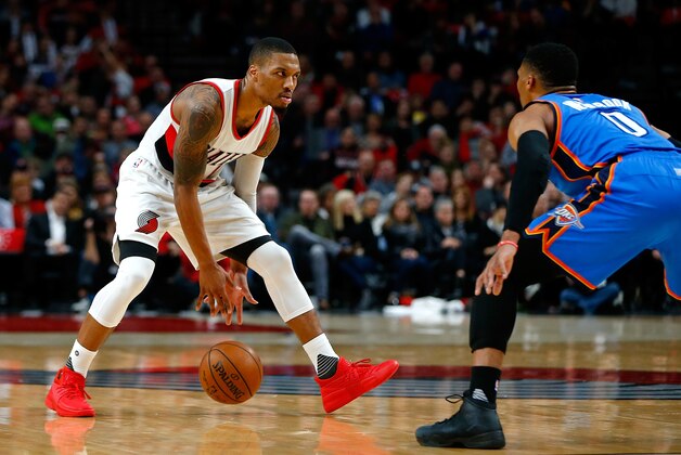 PORTLAND, OR - DECEMBER 13:  Damian Lillard #0 of the Portland Trail Blazers is guarded by Russell Westbrook #0 of  the Oklahoma City Thunder at Moda Center on December 13, 2016 in Portland, Oregon. NOTE TO USER: User expressly acknowledges and agrees that, by downloading and or using this photograph, User is consenting to the terms and conditions of the Getty Images License Agreement.  (Photo by Jonathan Ferrey/Getty Images)