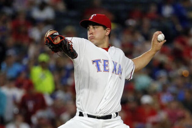 Texas Rangers starting pitcher Derek Holland (45) throws to the Los Angeles Angels in the second inning of a baseball game, Wednesday, Sept. 21, 2016, in Arlington, Texas. (AP Photo/Tony Gutierrez)