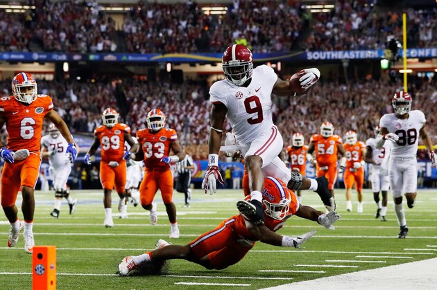 ATLANTA, GA - DECEMBER 03:  Bo Scarbrough #9 of the Alabama Crimson Tide leaps over the tackle of Chauncey Gardner #23 of the Florida Gators in the third quarter during the SEC Championship game at the Georgia Dome on December 3, 2016 in Atlanta, Georgia.  (Photo by Kevin C. Cox/Getty Images)