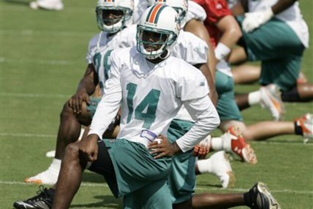 Miami Dolphins' P.K. Sam (14) stretches during football training camp in Davie, Fla., Monday, July 30, 2007. (AP Photo/Alan Diaz)