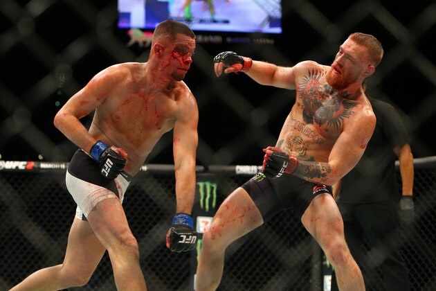 LAS VEGAS, NV - MARCH 5:   Nate Diaz punches Conor McGregor during UFC 196 at the MGM Grand Garden Arena on March 5, 2016 in Las Vegas, Nevada. (Photo by Rey Del Rio/Getty Images)