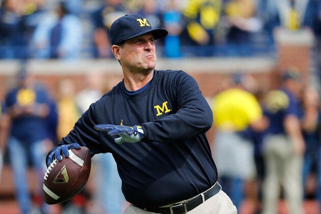 ANN ARBOR, MI - OCTOBER 01: Michigan Wolverines head football coach Jim Harbaugh throws the ball during the pregame warms ups prior to the start of the game against the Wisconsin Badgers at Michigan Stadium on October 1, 2016 in Ann Arbor, Michigan. (Photo by Leon Halip/Getty Images)