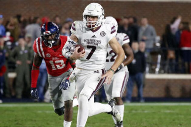 Mississippi State quarterback Nick Fitzgerald (7) sprints past Mississippi defensive back Tony Conner (12) on his way to a 61-yard touchdown run in the second half of an NCAA college football game in Oxford, Miss., Saturday, Nov. 26, 2016. Mississippi State won 55-20. (AP Photo/Rogelio V. Solis)