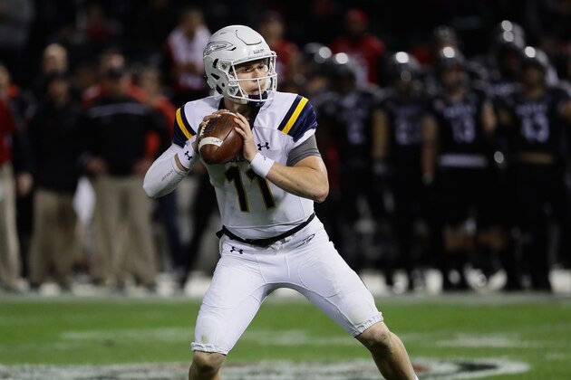 CHICAGO, IL - NOVEMBER 09:  Logan Woodside #11 of the Toledo Rockets looks for a receiver against the Northern Illinois Huskies at Guaranteed Rate  Field, home of the Chicago White Sox, on November 9, 2016 in Chicago, Illinois.  (Photo by Jonathan Daniel/Getty Images)