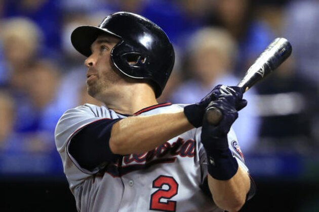 Minnesota Twins' Brian Dozier watches his solo home run off Kansas City Royals starting pitcher Edinson Volquez during the third inning of a baseball game at Kauffman Stadium in Kansas City, Mo., Friday, Aug. 19, 2016. (AP Photo/Orlin Wagner)