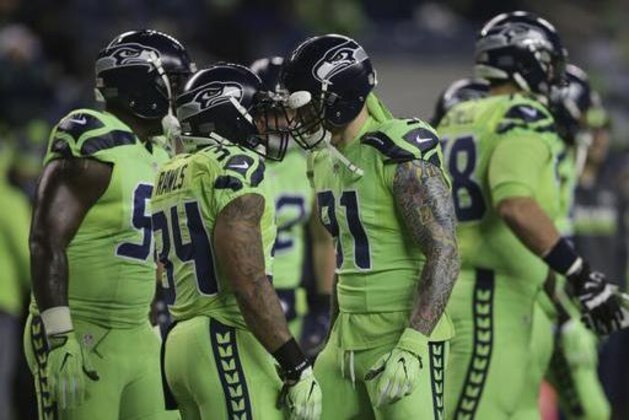 Seattle Seahawks including Thomas Rawls (34) and Cassius Marsh wear the NFL color rush uniforms before an NFL football game against the Los Angeles Rams, Thursday, Dec. 15, 2016, in Seattle. (AP Photo/Scott Eklund)